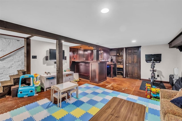 recreation room featuring beamed ceiling, recessed lighting, baseboards, and indoor bar