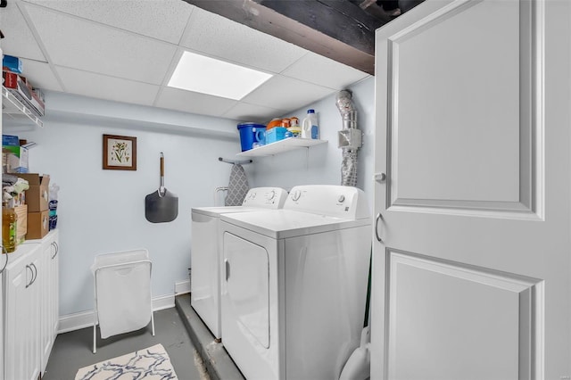 washroom with washing machine and clothes dryer, laundry area, and baseboards