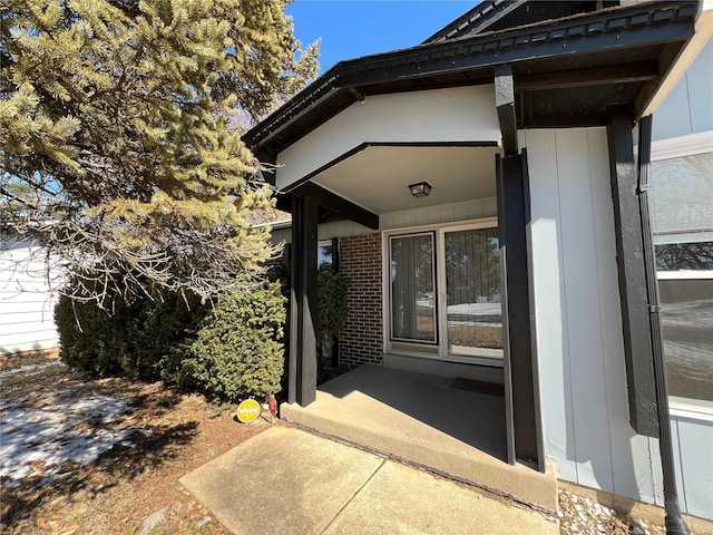 property entrance with brick siding