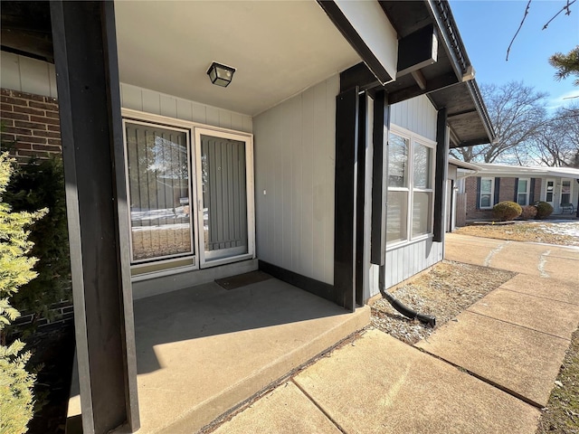 view of exterior entry featuring brick siding