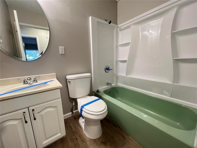 bathroom featuring bathtub / shower combination, toilet, wood finished floors, vanity, and baseboards