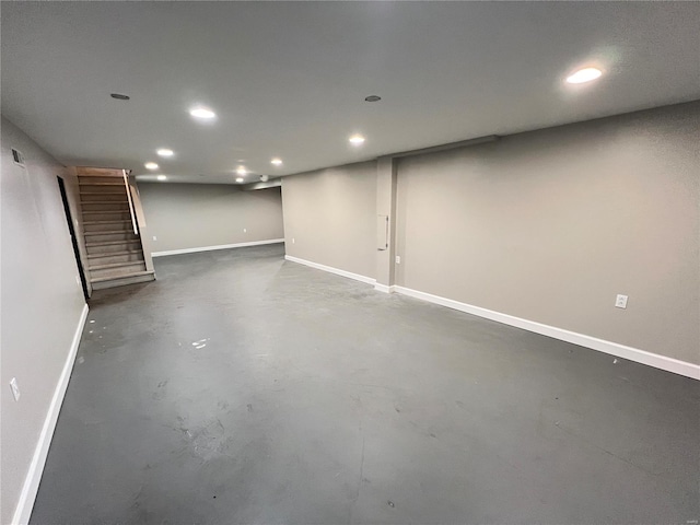 finished basement featuring stairs, recessed lighting, and baseboards