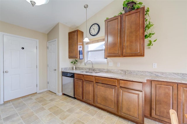 kitchen featuring dishwasher, decorative light fixtures, brown cabinetry, and a sink