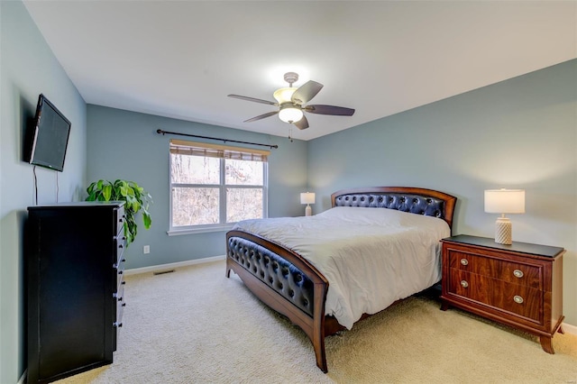 bedroom with visible vents, baseboards, carpet floors, and ceiling fan