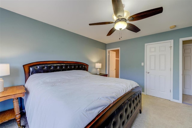 bedroom featuring light colored carpet, baseboards, and ceiling fan