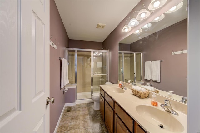 full bath with a sink, toilet, double vanity, and a shower stall