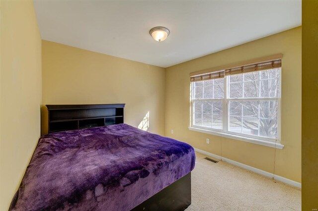 bedroom featuring visible vents, baseboards, and carpet