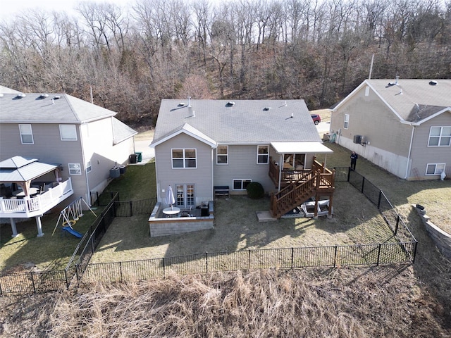 rear view of house with a yard, a fenced backyard, and a wooden deck