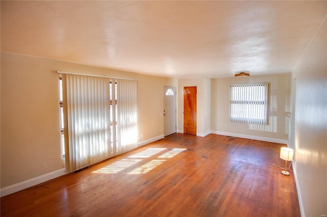 foyer with visible vents, baseboards, and wood finished floors