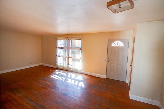 entryway featuring baseboards and wood finished floors