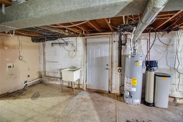 unfinished below grade area featuring a sink and gas water heater