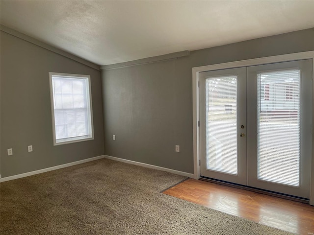 entryway featuring lofted ceiling, french doors, and baseboards