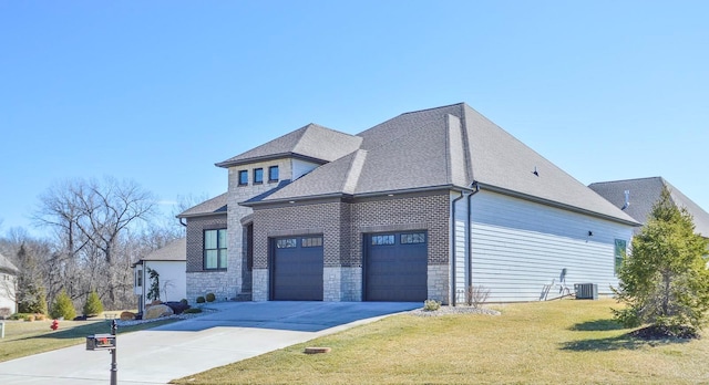 view of property exterior featuring an attached garage, a yard, stone siding, roof with shingles, and driveway