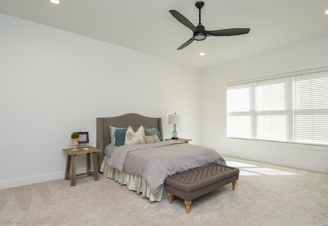 bedroom featuring light carpet, ceiling fan, baseboards, and recessed lighting