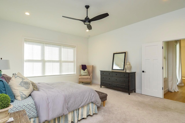 bedroom with baseboards, recessed lighting, a ceiling fan, and light colored carpet