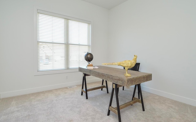 office with light carpet and baseboards