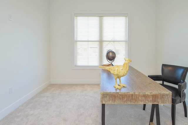 carpeted home office with baseboards