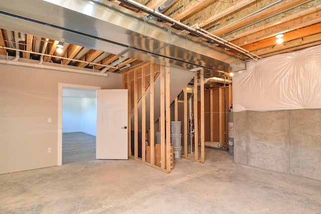 unfinished basement featuring water heater