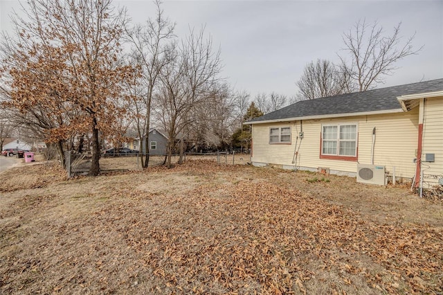 view of yard with ac unit and fence