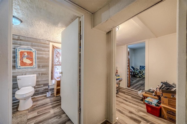 bathroom with toilet and wood finished floors