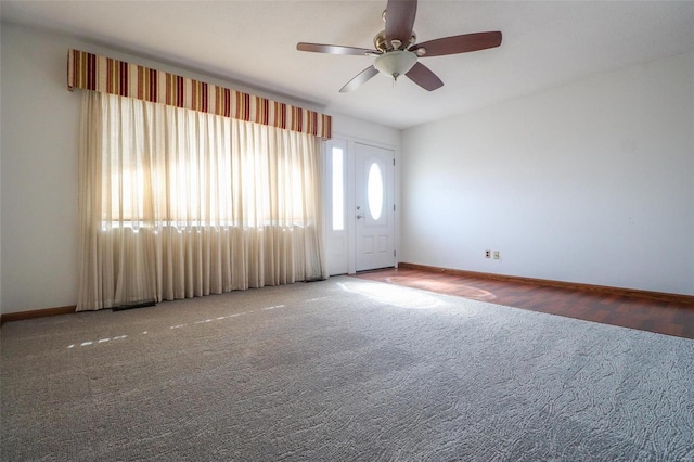 unfurnished room featuring carpet, a ceiling fan, and baseboards