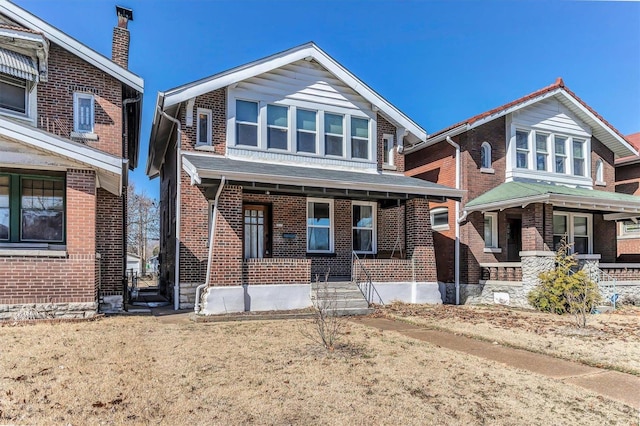 view of front of house with brick siding and covered porch