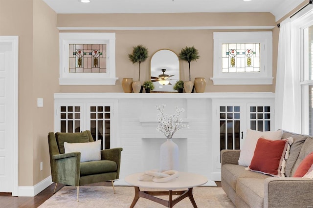 living room featuring recessed lighting, a fireplace, baseboards, and wood finished floors