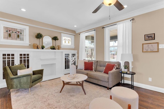 living area with recessed lighting, a fireplace, baseboards, and wood finished floors