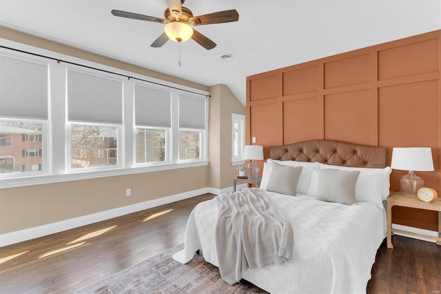 bedroom with wood finished floors, baseboards, and ceiling fan