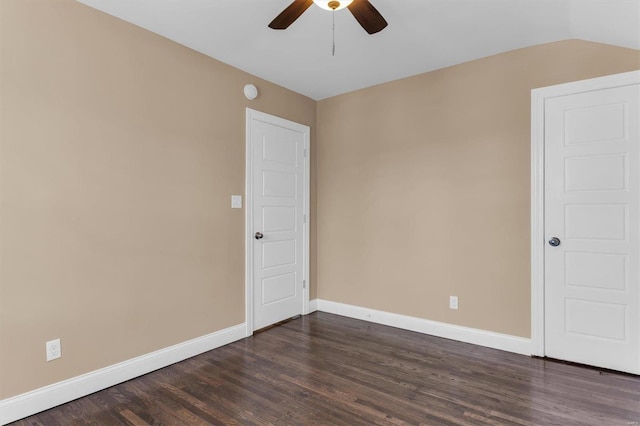 unfurnished room with dark wood finished floors, ceiling fan, lofted ceiling, and baseboards