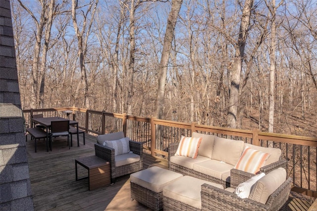 wooden terrace featuring outdoor dining space and an outdoor hangout area