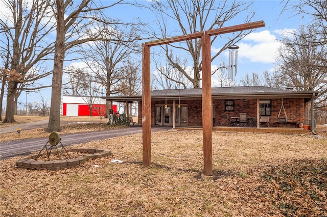 view of yard with aphalt driveway and an attached carport