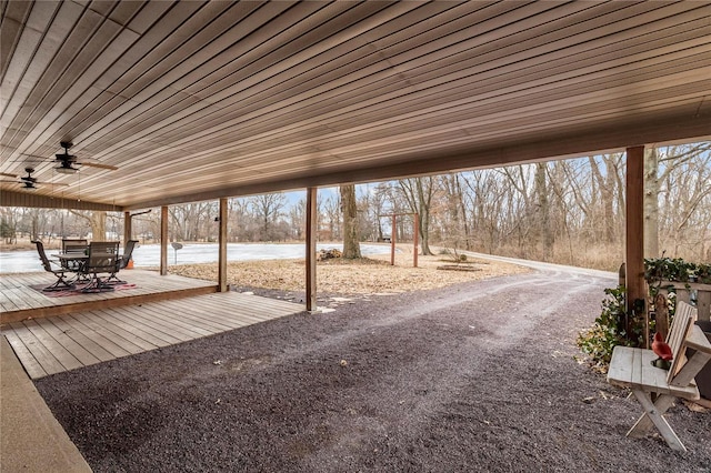 view of patio with a ceiling fan, outdoor dining space, and a water view