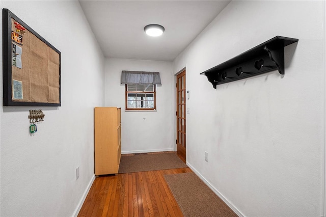 entryway with baseboards and hardwood / wood-style flooring