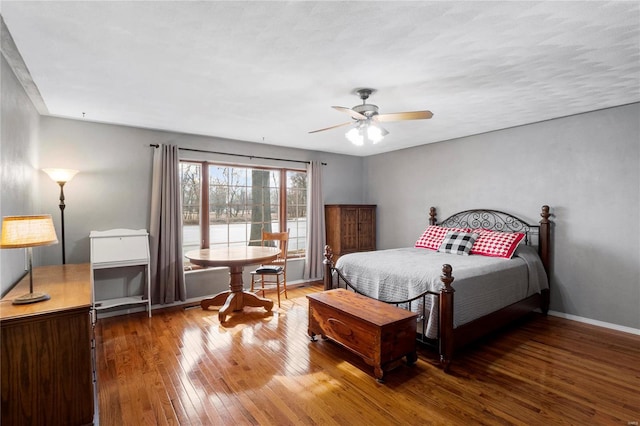 bedroom featuring wood-type flooring and baseboards