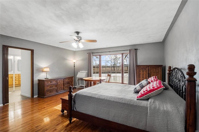 bedroom featuring wood-type flooring, connected bathroom, ceiling fan, a textured ceiling, and baseboards