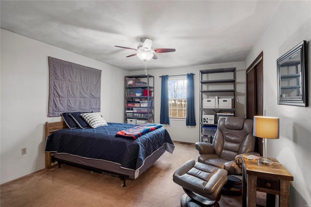 carpeted bedroom featuring ceiling fan and baseboards