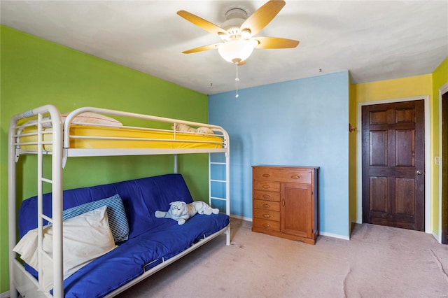 carpeted bedroom featuring a ceiling fan and baseboards