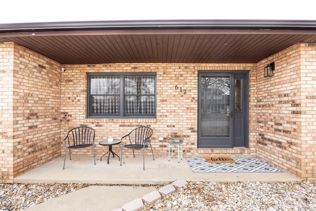 property entrance with brick siding