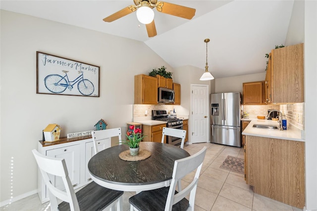 dining area with lofted ceiling, ceiling fan, and light tile patterned flooring