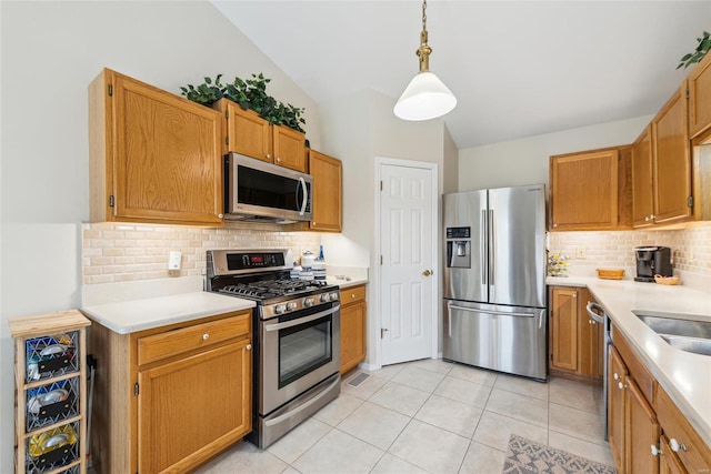 kitchen featuring vaulted ceiling, stainless steel appliances, tasteful backsplash, and light countertops