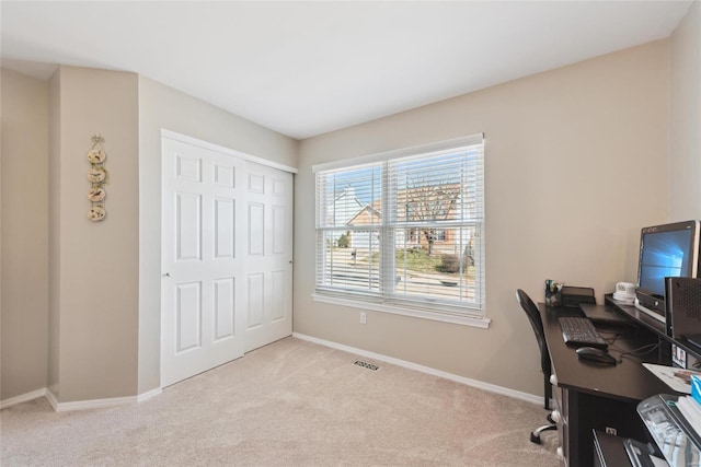 office space with carpet flooring, visible vents, and baseboards