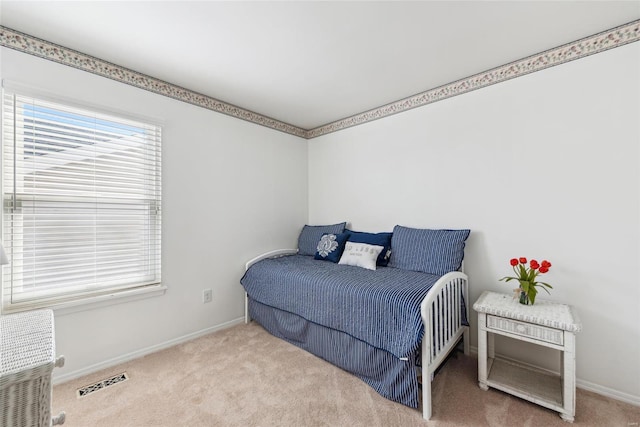 carpeted bedroom featuring visible vents and baseboards