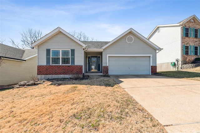 single story home featuring a garage, concrete driveway, brick siding, and a front lawn