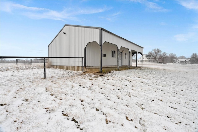 view of pole building with fence