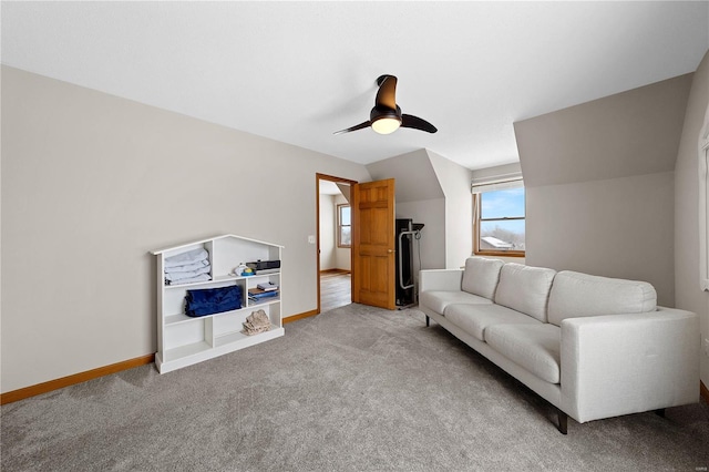 living area with light colored carpet, baseboards, and ceiling fan