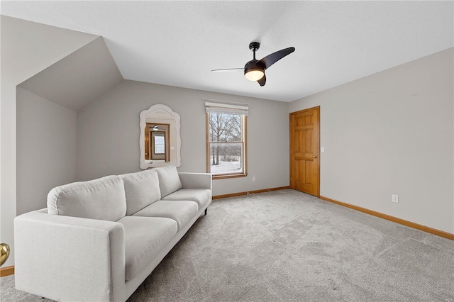 living area with baseboards, light colored carpet, lofted ceiling, and ceiling fan