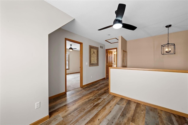 empty room featuring visible vents, baseboards, and wood finished floors