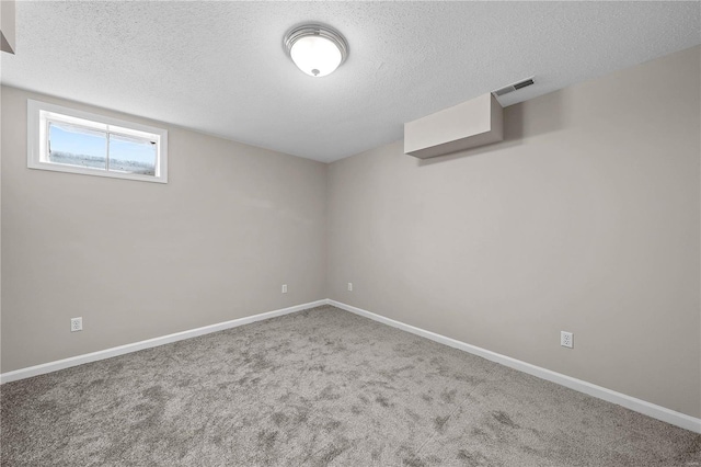 interior space featuring baseboards, a textured ceiling, and carpet flooring