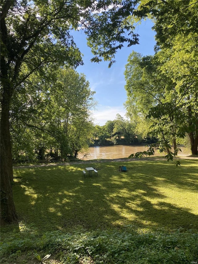 exterior space featuring a water view and a lawn